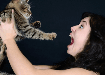 woman excited while holding cat
